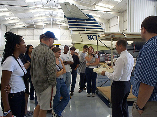 Photo of past students touring Aeromet in Tulsa, OK.